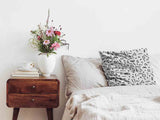 White health pillow with black shapes.