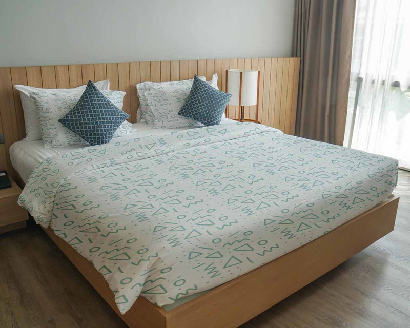 Therapy blanket and bedding set, white with blue shapes.