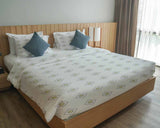 Therapy blanket and bedding set, white with green circles.
