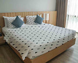 Therapy blanket and bedding set, white with black triangles.