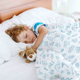 Therapy blanket and bedding set, white, with toys.