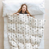 Therapy blanket and bedding set, white with many black arrows.