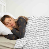 Therapy blanket and bedding set, white with lettering.