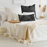 Health pillow, black with spiderweb pattern.
