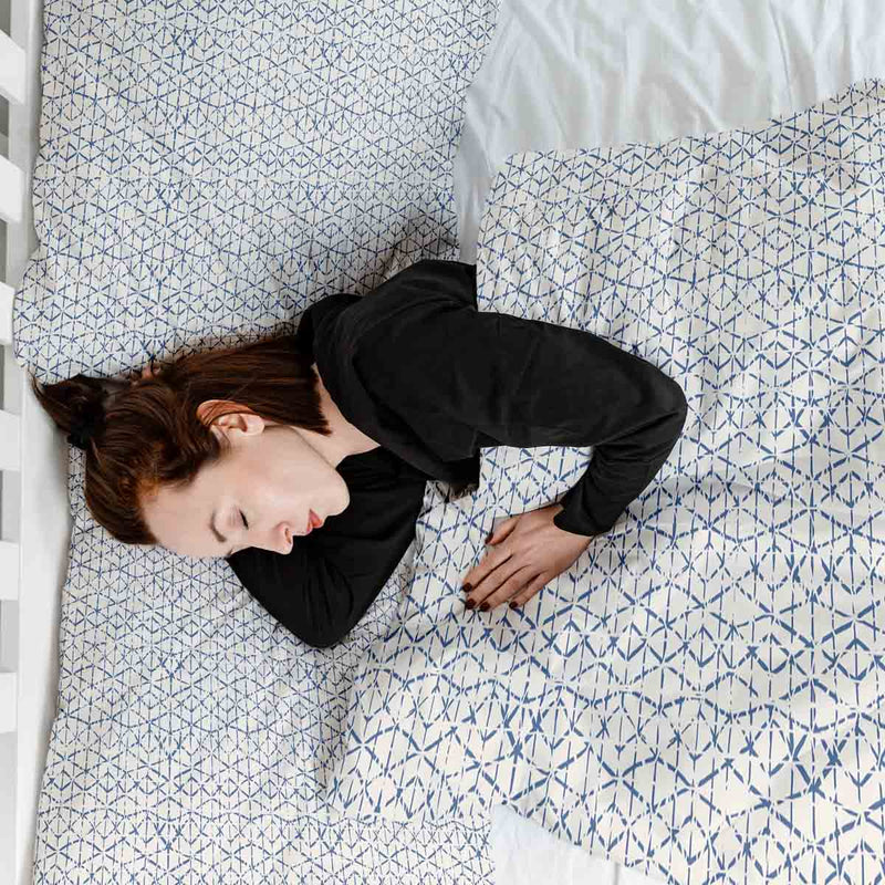Therapy blanket and bedding set, white with delicate blue shapes.