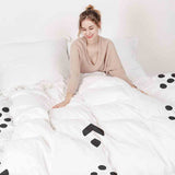 Therapy blanket and bedding set, white with black arrow pattern.