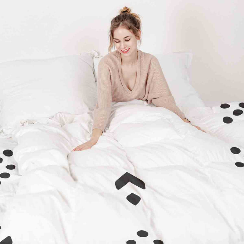 Therapy blanket and bedding set, white with black arrow pattern.