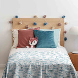 Therapy blanket and bedding set, white, with toys.