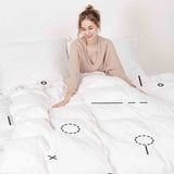 Therapy blanket and bedding set, white with black shapes.