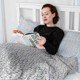 Therapy blanket and bedding set, white with delicate blue shapes.