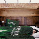 Therapy blanket and bedding set in green with lettering.