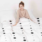 Therapy blanket and bedding set, white with black dots.