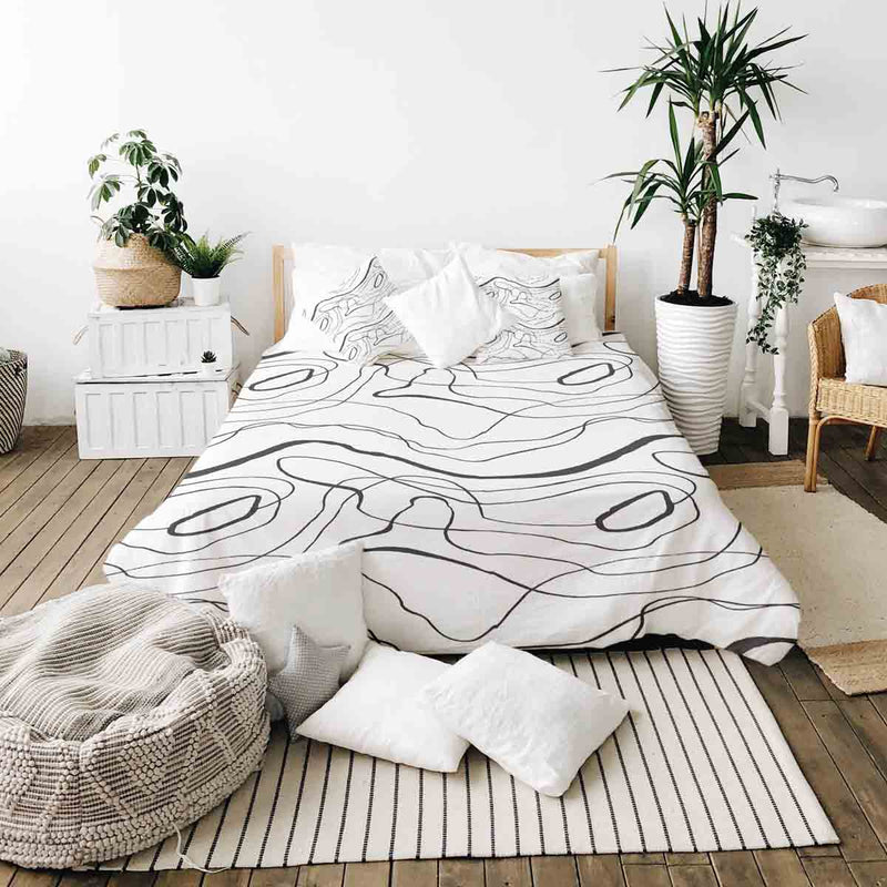 Set de ropa de cama con mantas terapéuticas y líneas serpenteantes negras