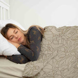 Therapy blanket bedding set, beige with black leaf pattern.