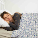 Therapy blanket and bedding set, white with delicate blue shapes.