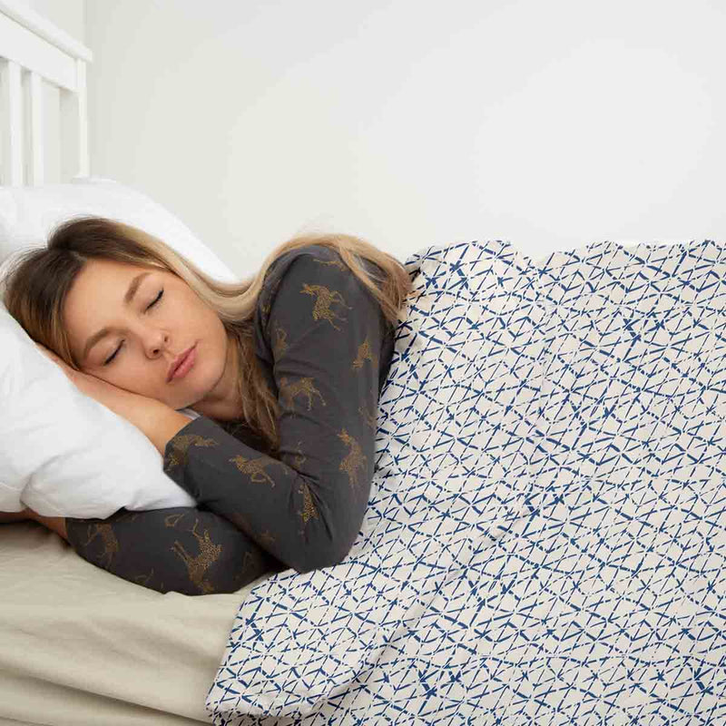 Therapy blanket and bedding set, white with delicate blue shapes.